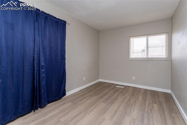 138 Hoedown Cir, Fountain, CO 80817 - unfurnished room with baseboards, a textured ceiling, and wood finished floors