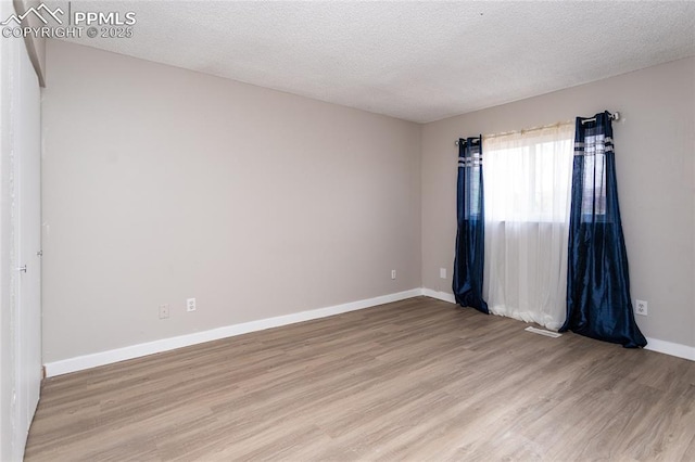 138 Hoedown Cir, Fountain, CO 80817 - spare room with baseboards, light wood-type flooring, and a textured ceiling