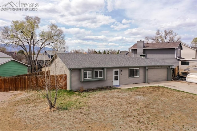 138 Hoedown Cir, Fountain, CO 80817 - single story home featuring an attached garage, a chimney, fence, concrete driveway, and roof with shingles