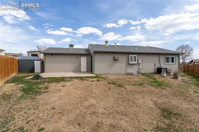138 Hoedown Cir, Fountain, CO 80817 - back of property with a patio area, a fenced backyard, central AC unit, and a wall mounted air conditioner