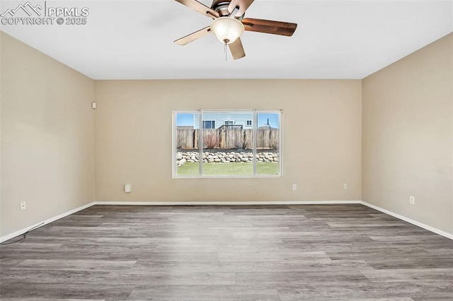 empty room with ceiling fan, baseboards, and wood finished floors