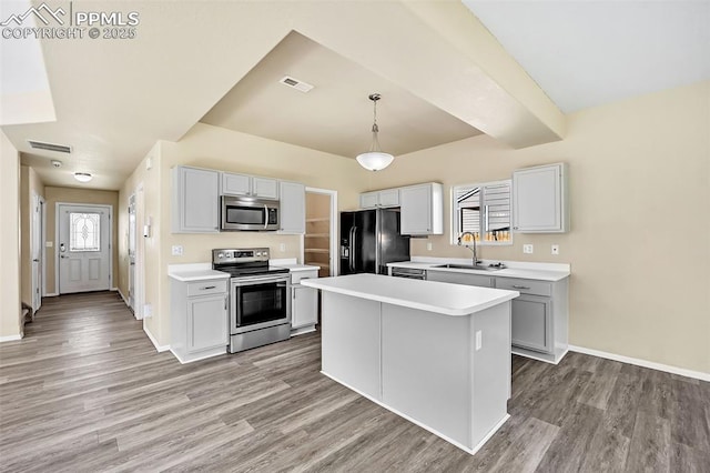 kitchen with stainless steel appliances, visible vents, a sink, and light wood-style floors
