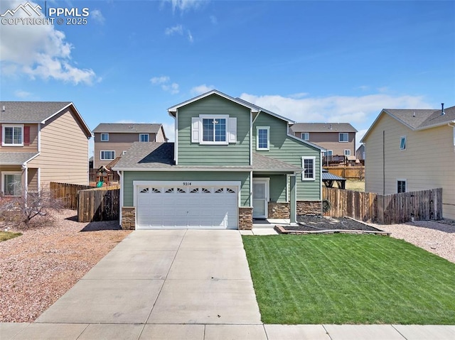 view of front of home with driveway, fence, and stone siding
