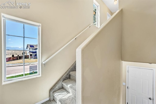 staircase featuring baseboards