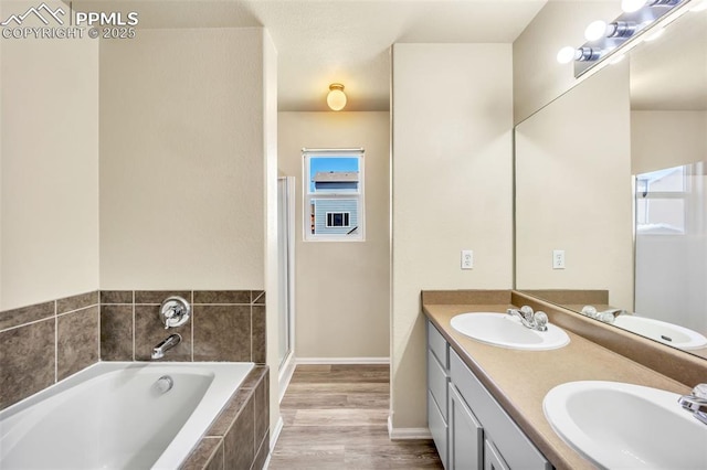 full bathroom with a garden tub, a sink, and double vanity
