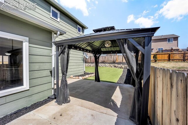 view of patio with a fenced backyard and a gazebo