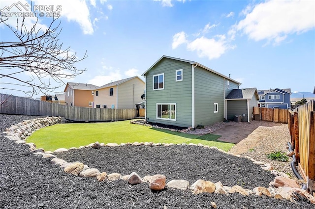 rear view of property featuring cooling unit, a patio area, a lawn, and a fenced backyard