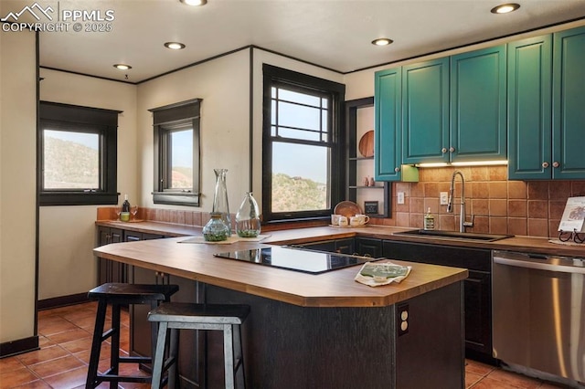 kitchen featuring butcher block counters, dishwasher, a sink, and black electric stovetop