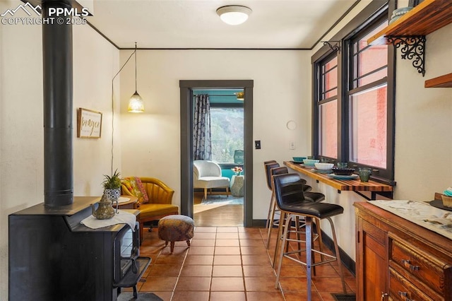 office featuring a wood stove and dark tile patterned floors