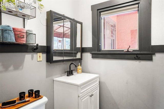 half bathroom with toilet and vanity