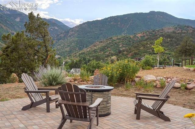 view of patio / terrace featuring central AC and a mountain view