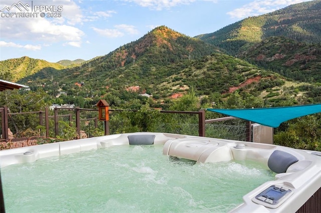 view of pool featuring a mountain view and a hot tub