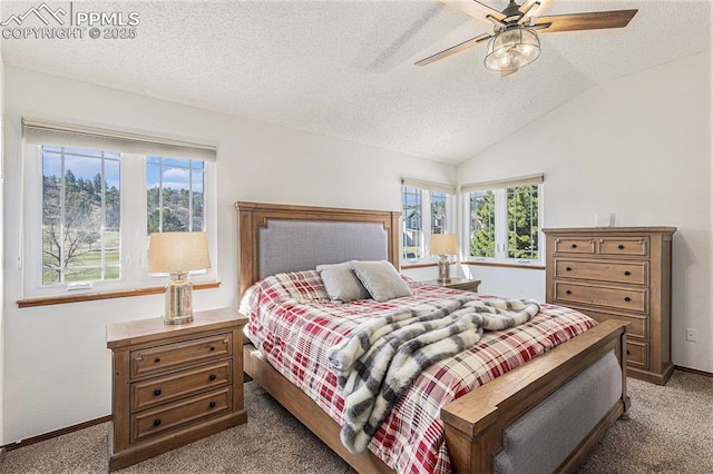 bedroom with a textured ceiling, a ceiling fan, vaulted ceiling, carpet flooring, and baseboards