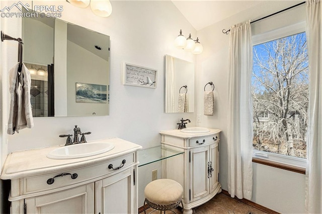 bathroom with a sink, two vanities, and tile patterned flooring