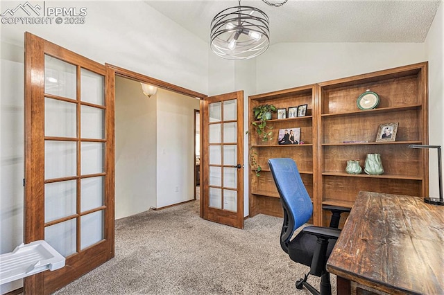 home office featuring a chandelier, a textured ceiling, vaulted ceiling, french doors, and carpet flooring