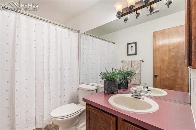 bathroom featuring a notable chandelier, vanity, visible vents, and toilet