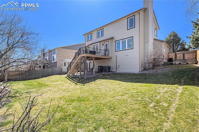 back of house with central air condition unit, a lawn, fence, stairs, and a deck