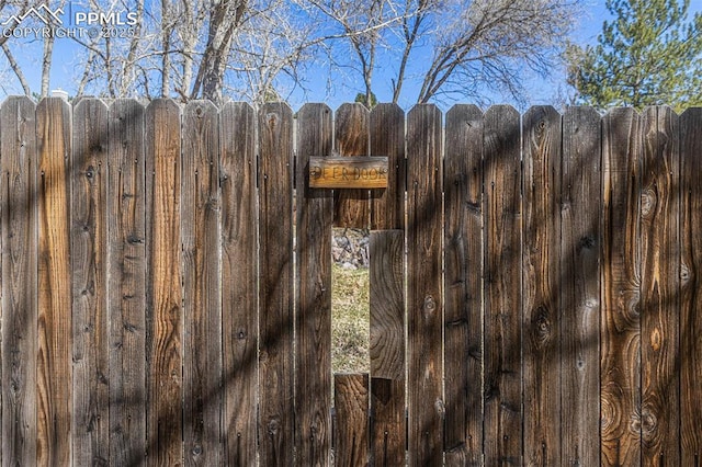 details featuring fence and a gate