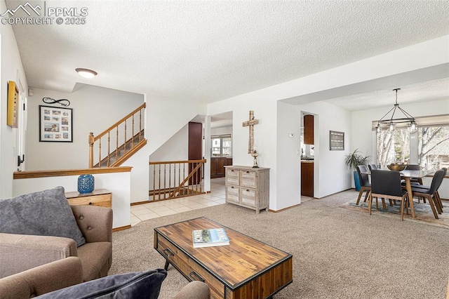 living area featuring a textured ceiling, a healthy amount of sunlight, and light colored carpet