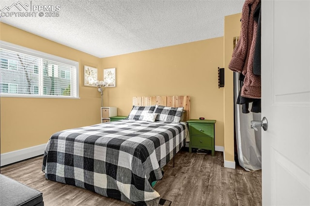 5030 El Camino Dr Unit 1, Colorado Springs, CO 80918 - bedroom with baseboards, a textured ceiling, and wood finished floors