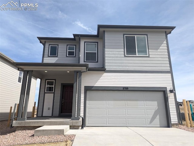 traditional home with an attached garage, driveway, and a porch