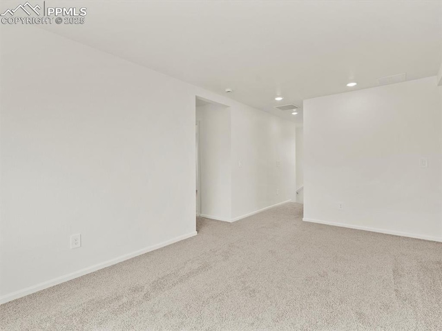 empty room with baseboards, carpet floors, visible vents, and recessed lighting