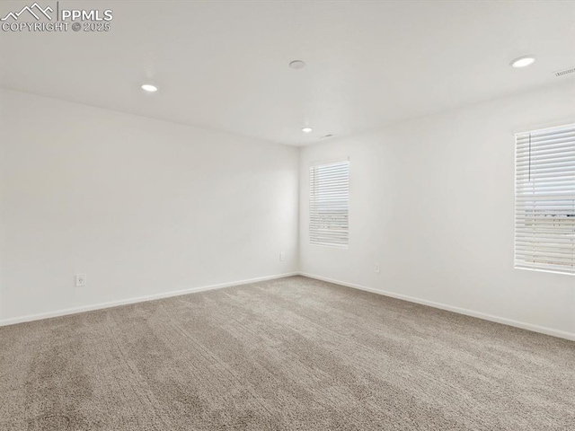 carpeted empty room with recessed lighting and baseboards