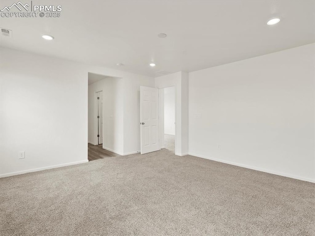 carpeted empty room with baseboards and recessed lighting