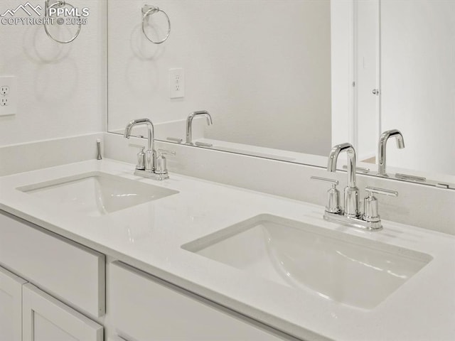 bathroom featuring a sink and double vanity