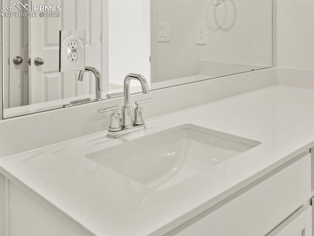 interior details featuring a sink and double vanity