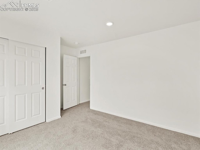 unfurnished bedroom featuring baseboards, visible vents, carpet, and recessed lighting