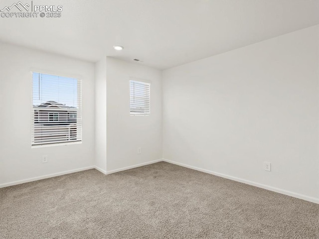carpeted spare room with recessed lighting, visible vents, and baseboards