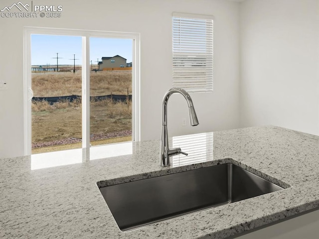 details with light stone counters and a sink