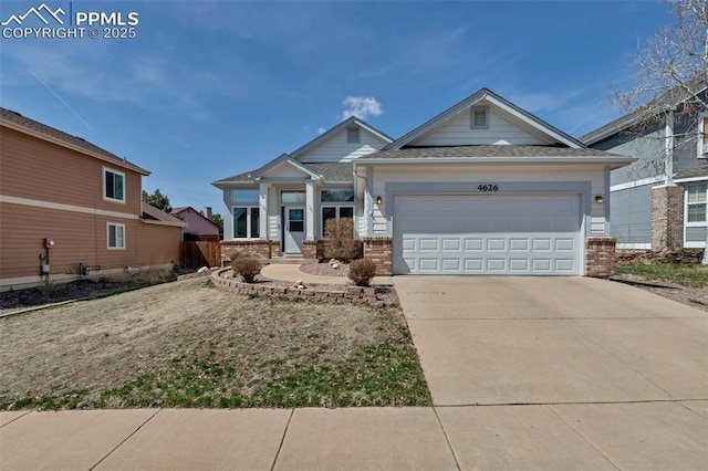 4626 Hotspur Dr, Colorado Springs, CO 80922 - craftsman-style house with concrete driveway, brick siding, and a garage