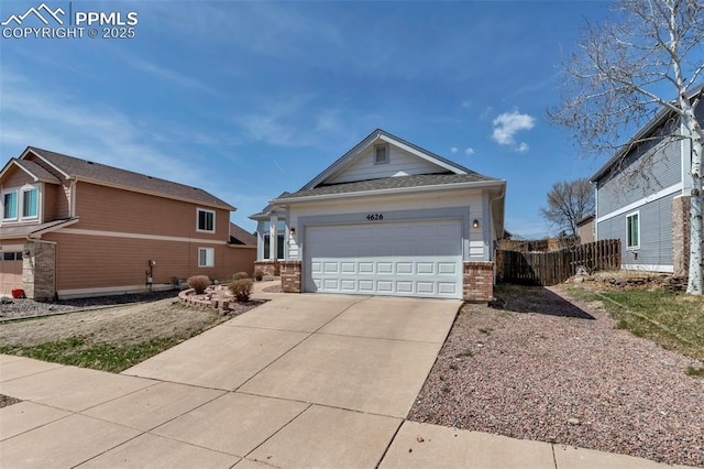 4626 Hotspur Dr, Colorado Springs, CO 80922 - view of property exterior with concrete driveway, brick siding, and fence