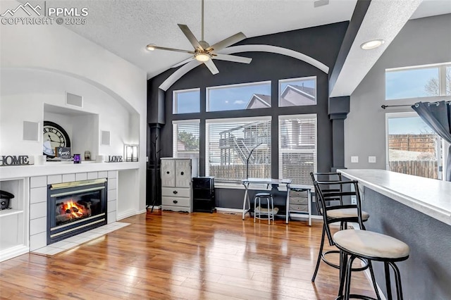 4626 Hotspur Dr, Colorado Springs, CO 80922 - interior space featuring hardwood / wood-style floors, visible vents, a fireplace, and ceiling fan
