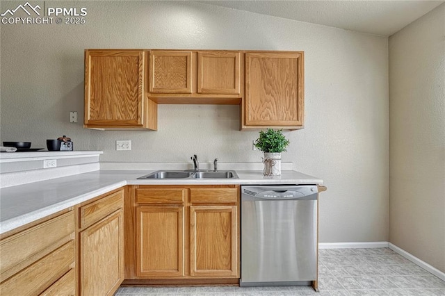5542 Sunshade Pt, Colorado Springs, CO 80923 - kitchen with a sink, light countertops, stainless steel dishwasher, and baseboards