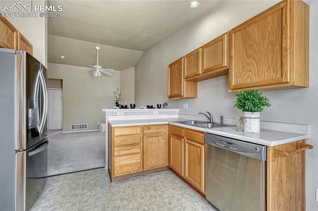 5542 Sunshade Pt, Colorado Springs, CO 80923 - kitchen featuring appliances with stainless steel finishes, a ceiling fan, visible vents, lofted ceiling, and a sink