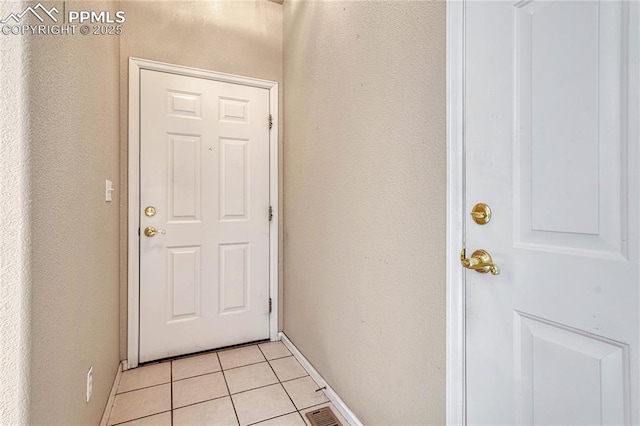 5542 Sunshade Pt, Colorado Springs, CO 80923 - entryway featuring light tile patterned flooring, baseboards, a textured wall, and visible vents
