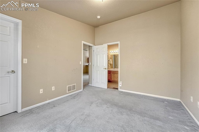 5542 Sunshade Pt, Colorado Springs, CO 80923 - unfurnished bedroom featuring visible vents, baseboards, ensuite bath, and carpet floors