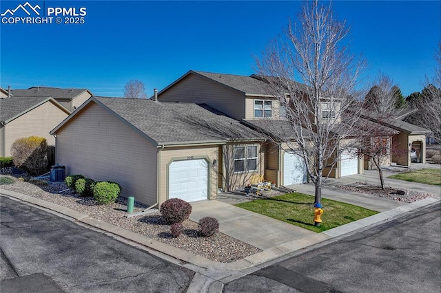 5542 Sunshade Pt, Colorado Springs, CO 80923 - traditional home featuring an attached garage, a shingled roof, cooling unit, and concrete driveway