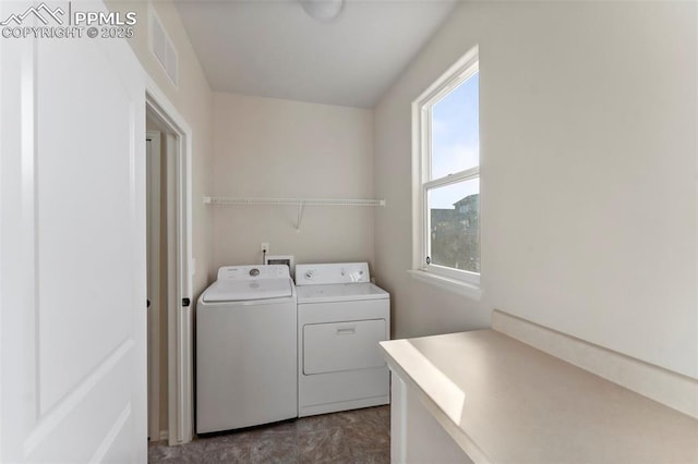 laundry area featuring visible vents, washer and clothes dryer, laundry area, and plenty of natural light