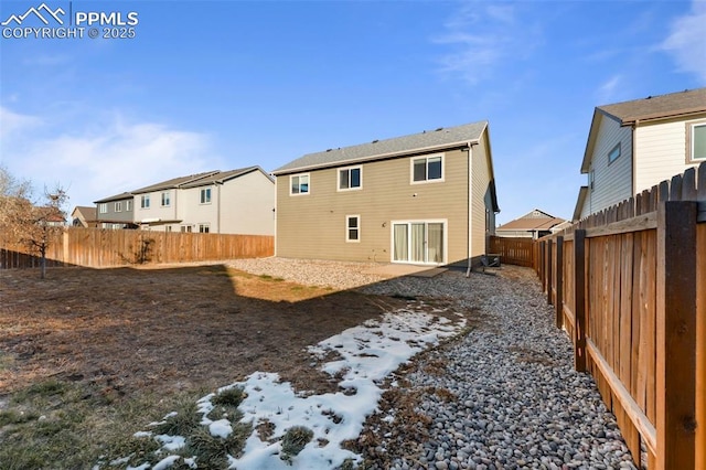 rear view of house with a residential view and a fenced backyard