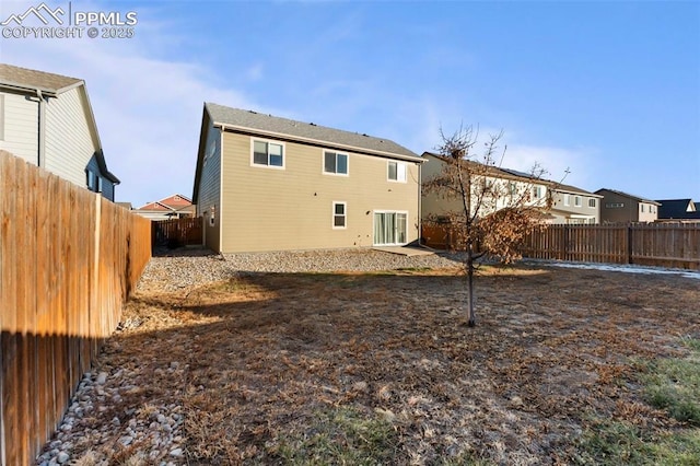 back of property with a fenced backyard