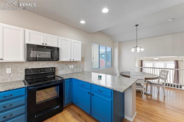 kitchen featuring blue cabinets, black appliances, white cabinets, a peninsula, and a notable chandelier