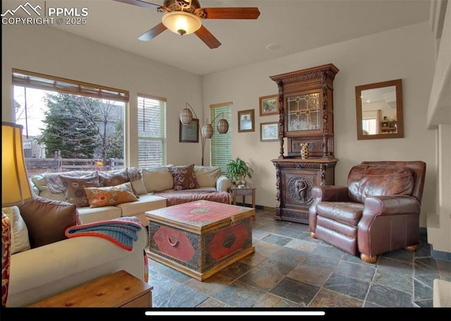 8723 Stony Creek Dr, Colorado Springs, CO 80924 - living area with stone tile floors, ceiling fan, and baseboards