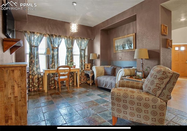 8723 Stony Creek Dr, Colorado Springs, CO 80924 - living area with a textured wall and stone tile floors