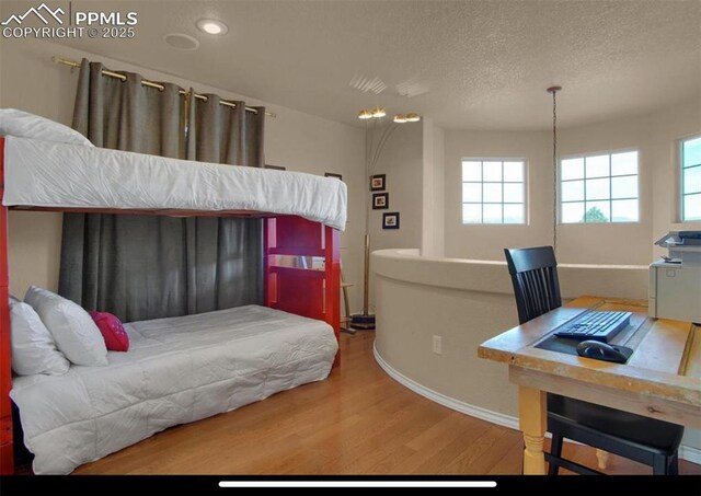 8723 Stony Creek Dr, Colorado Springs, CO 80924 - bedroom featuring baseboards, wood finished floors, multiple windows, a textured ceiling, and recessed lighting