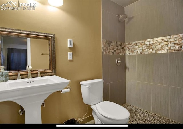 8723 Stony Creek Dr, Colorado Springs, CO 80924 - bathroom with a tile shower, toilet, and a sink