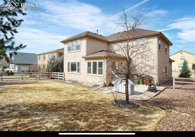 8723 Stony Creek Dr, Colorado Springs, CO 80924 - rear view of property featuring stucco siding and a fenced backyard